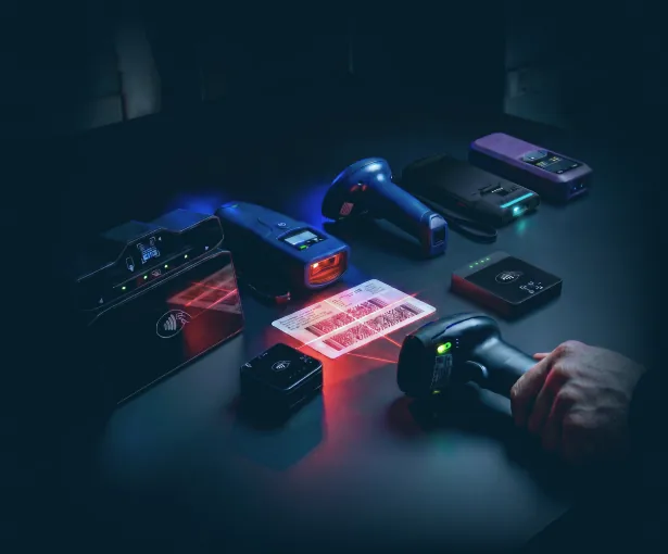 Identity document scanners from multiple manufacturers A range of desktop and handheld identity document scanners, one reading the barcode on a driver's license.