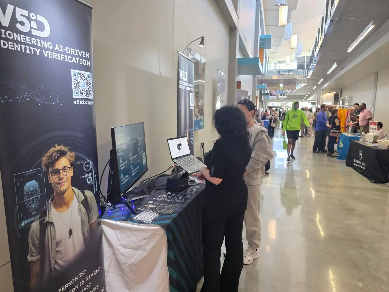 AI Identity Verification Discussion V5iD® CEO discussing AI identity verification solutions with attendee