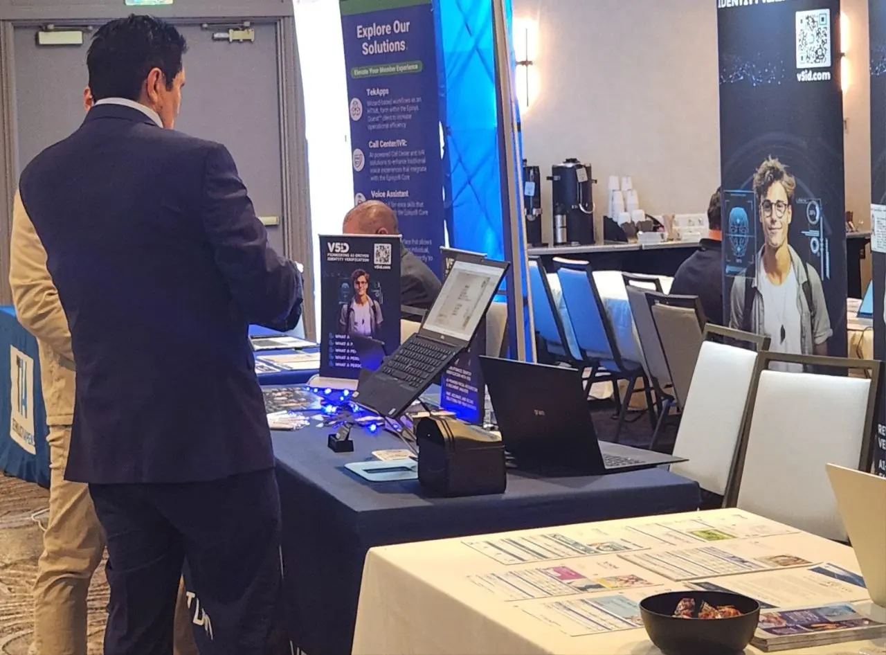 V5iD® CTO engaging with a conference visitor at the V5iD booth, demonstrating the functionality of the Identity Verification Kiosk during a live session at SymWest