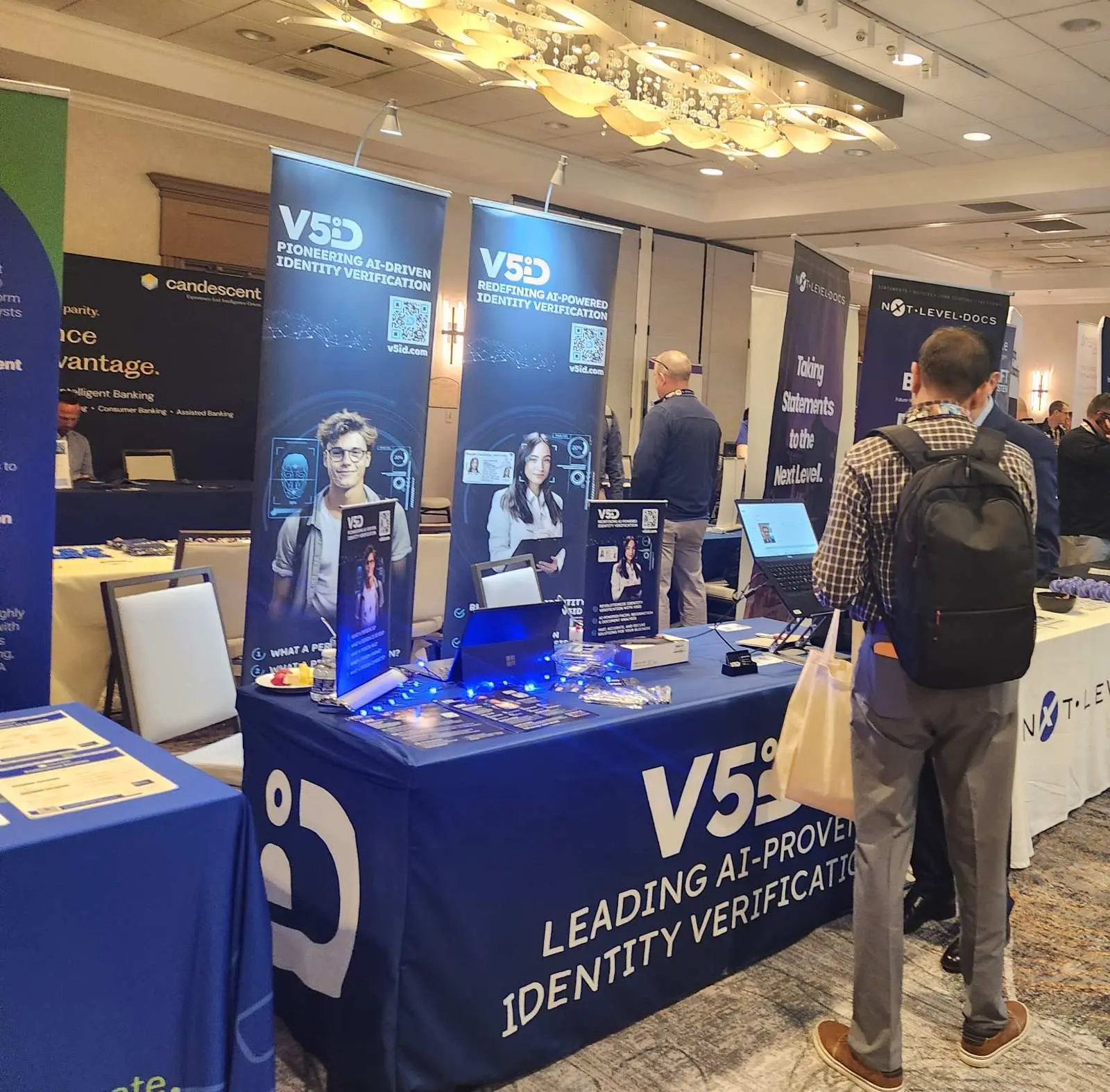 V5iD® CTO speaking with a conference attendee at the V5iD booth, discussing the Remote Identity Verification feature designed for call centers to verify member identities remotely