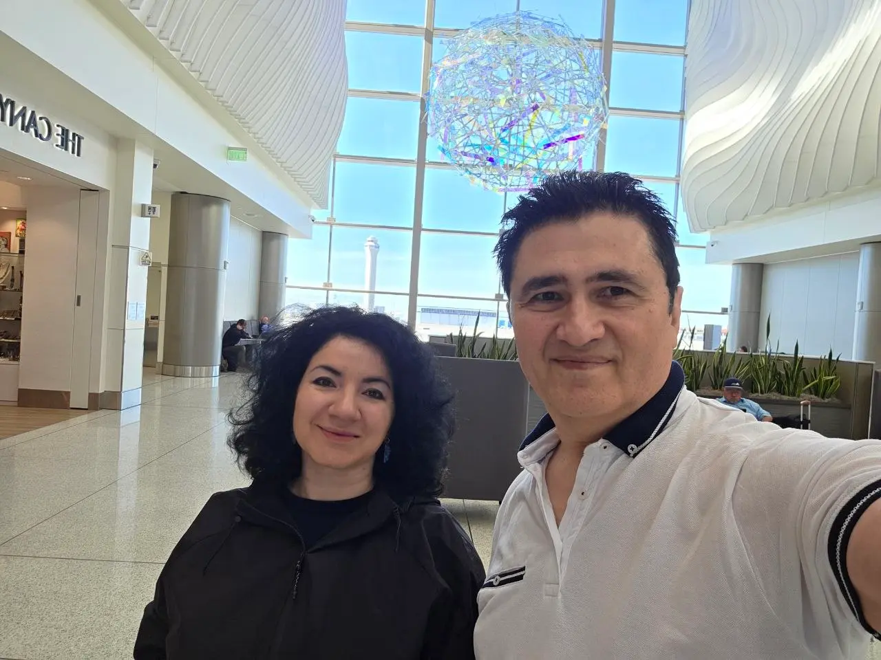 V5iD® CTO and CEO posing for a selfie at the Salt Lake City International Airport, dressed in comfortable travel clothes and ready to fly back to Portland after the SymWest 2026 conference concludes