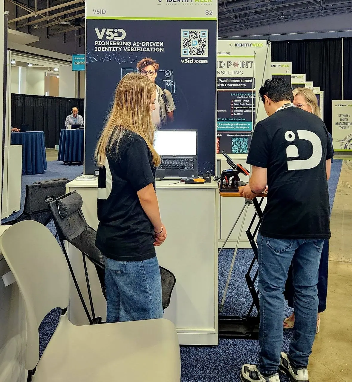 V5iD staff demonstrating AI facial recognition and document analysis tools to attendees at the Identity Week America 2026 exhibition booth