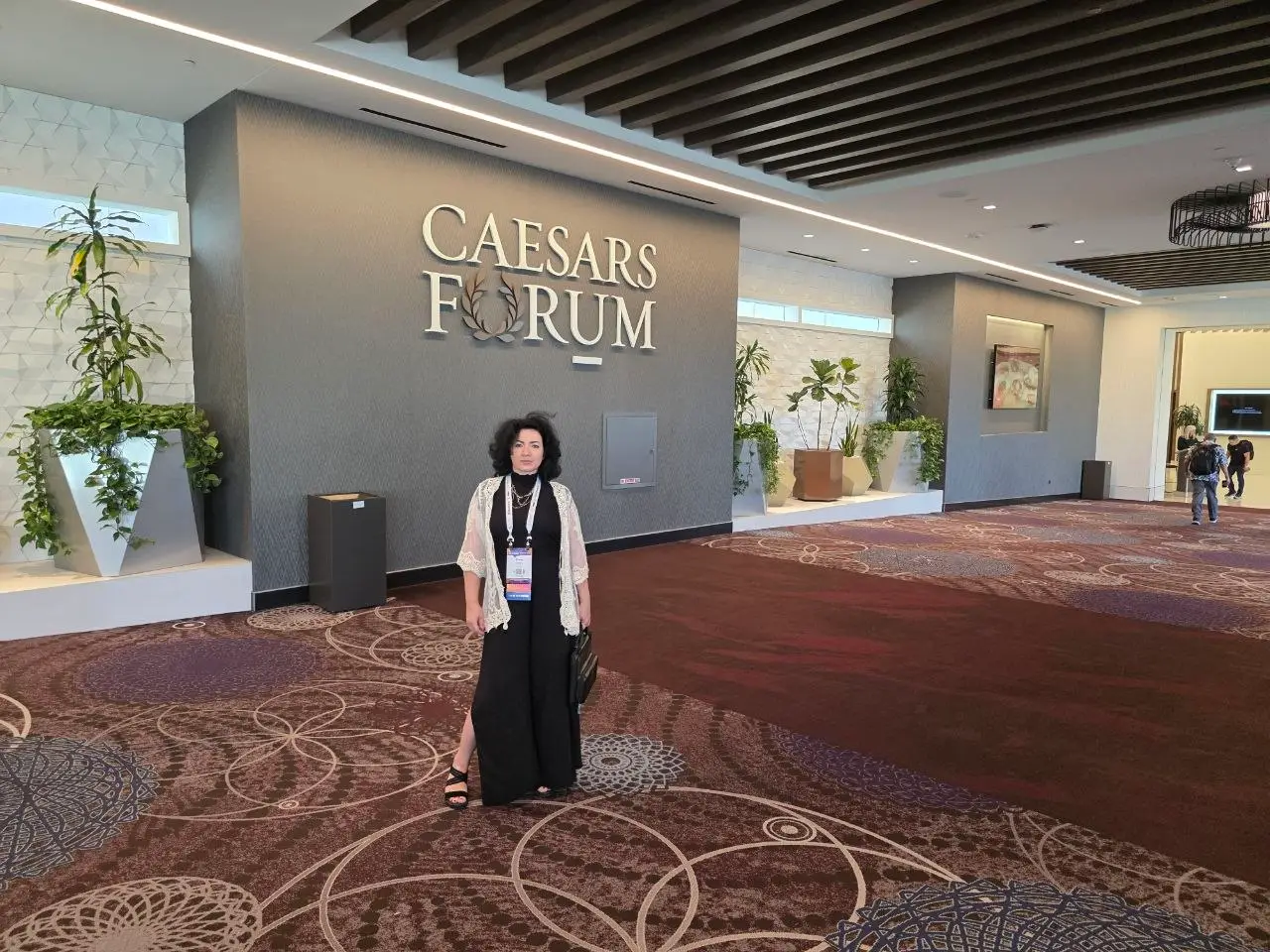 V5iD CEO at Caesars Forum lobby during RSPA RetailNOW 2026 V5iD CEO standing in the Caesars Forum lobby in front of the large “Caesars Forum” wall sign during RSPA RetailNOW 2026 in Las Vegas.