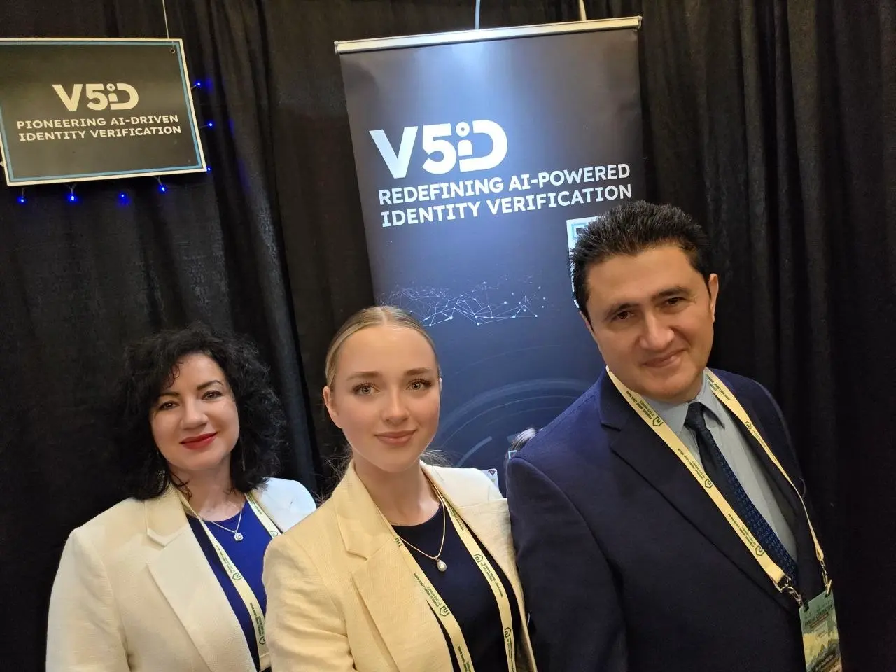 V5iD Executive Team Showcasing AI Identity Solutions at 2026 Quad-State Bankers Convention V5iD leadership — CEO, CTO, and summer intern — posing in front of AI-powered identity verification banners at the 2026 Quad-State Bankers Convention